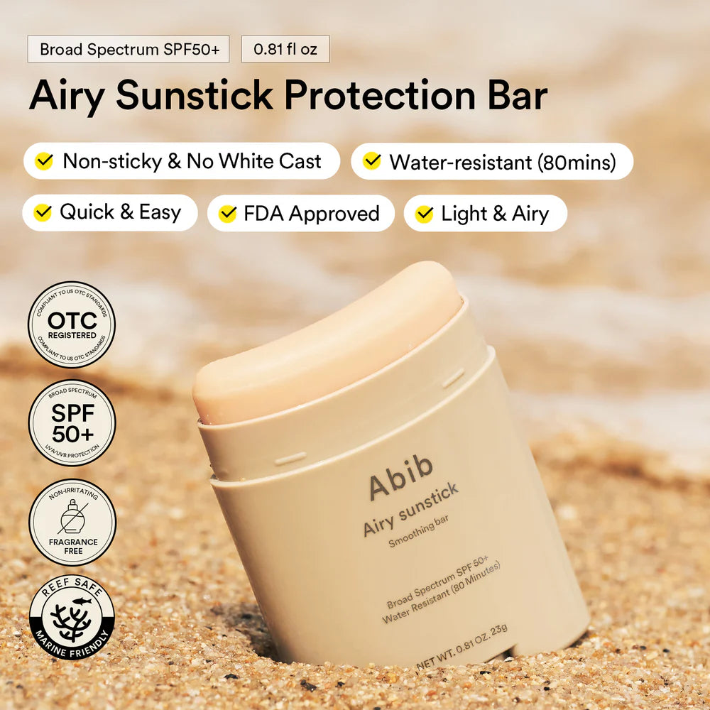 Abib Airy Sunstick Protection Bar on sand with product features listed