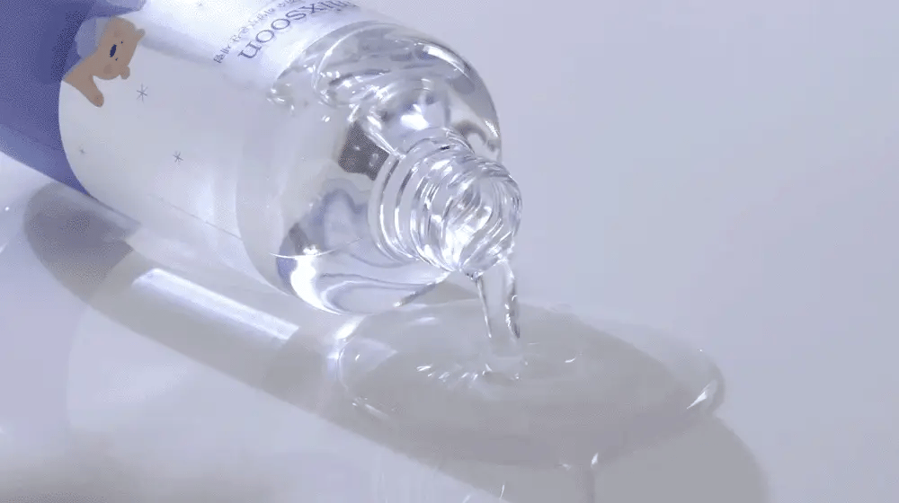 Close-up of a clear bottle Mixsoon Glacier Water Hyaluronic Acid Serum with a purple cap on a white background