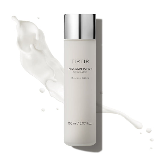 TIRTIR milk skin toner bottle with white liquid splashes on a light beige background